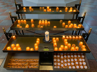 Fire in the church, burning candles. Candles flame close up. Place for candles