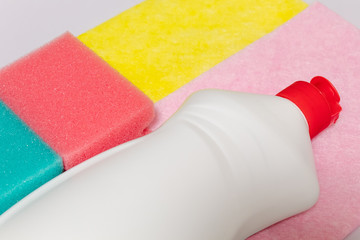 bottle of dishwashing liquid with sponges