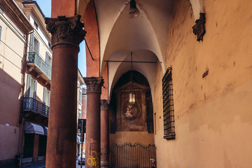 Characteristic portico with old Our Lady shrine on Barberia Street in historic part of Bologna, Italy © Fotokon