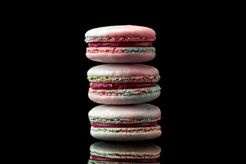 colorful macaroon cookies on a black background