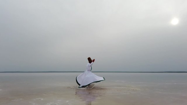 sunset and whirling at the sea, sufi. sufi whirling (Turkish: Semazen) is a form of Sama or physically active meditation which originated among Sufis. 4k