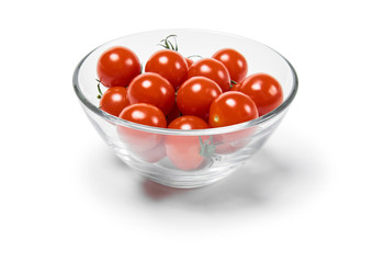 cherry tomatoes in a glass bowl, isolated on a white background