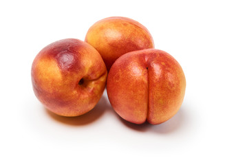three ripe nectarines on a white background