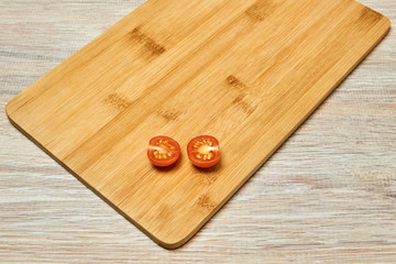 halved small cherry tomato on a cutting board on a table