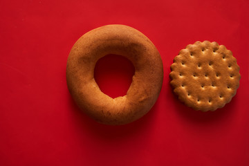 bagel and cracker on a red background closeup