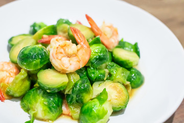 Delicious Stir-fried Brussels Sprouts with shrimp on dish. Close up