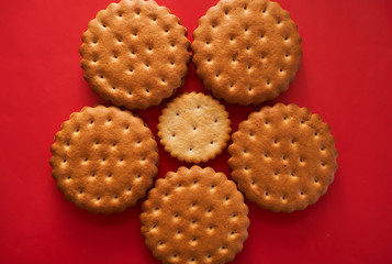 biscuits on a red background flower top view