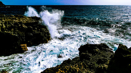 Spritzendes Wasser eine Welle an der Küste in Teneriffa bei Los Abrigos an einem warmen Sommertag