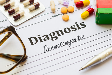 Dermatomyositis - Antiphospholipid Syndrome - Diagnosis written on a piece of white paper with medication and pills