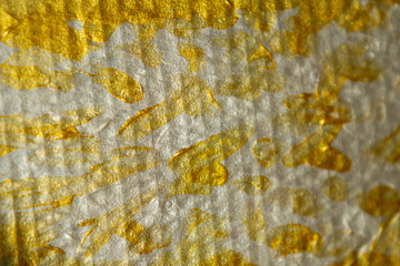 Blurred shining Golden texture acrylic paint on cardboard. Hand drawing, real texture, close-up.