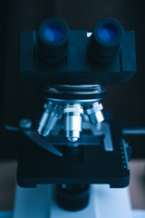 Fototapeta na wymiar Focus on microscope with metal lens for experiments, educational demonstrations in clinical laboratories. Medicine researching concept. Blurred background