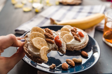 eating breakfast at home. cup of tea with lemon and banana and almond toast. breakfast at home. breakfast idea. simple breakfast decoration. eating a toast