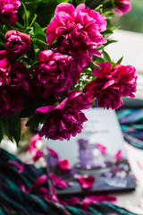 bouquet of pink peonies. big bouquet of peonies and a book. home decoration idea. spend time home nicely