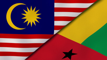 The flags of Malaysia and Guinea Bissau. News, reportage, business background. 3d illustration