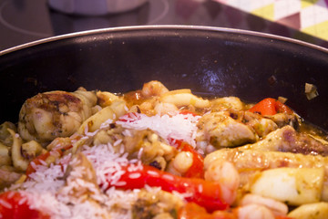 Vegetable stir fry with seafood and chicken to prepare paella