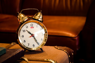Vintage brass alarm clock on table.