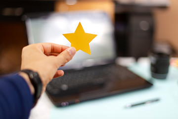 Person holding a five star paper, excellent rating