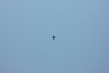 a plane flying alone in the clear morning sky