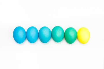 Easter multicolor eggs isolated on a white background. Rainbow. Copy space. Flat lay. Top view.