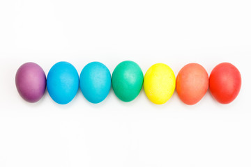 Fototapeta na wymiar Easter multicolor eggs isolated on a white background. Rainbow. Copy space. Flat lay. Top view.