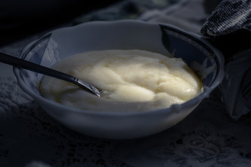 Plate of semolina porridge. Semolina porridge in the morning sun. Healthy breakfast concept