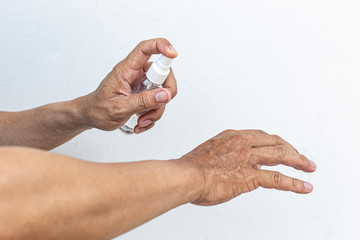 Man uses a spray of alcohol to get rid of bacteria and viruses, Inhibition and prevention of...