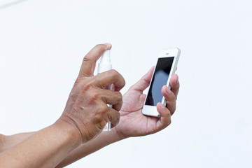 Men use alcohol spray to get rid of bacteria and viruses on mobile phones, Inhibition and...