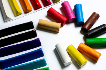 Naklejka premium many multi-colored plasticine sticks lie on a white background. isolate. for children's creativity