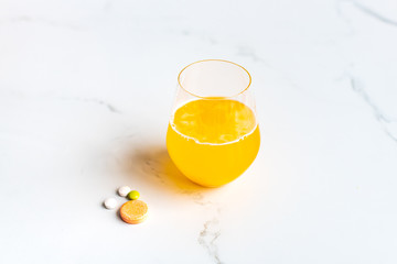 Multivitamin tablets and effervescent tablet with a glass of water
