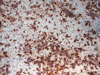 Worn rusty metal surface with cracking texture background.