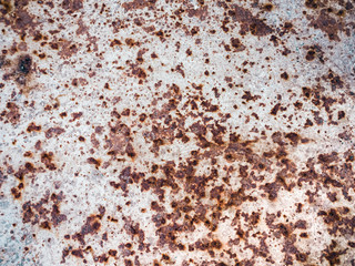 Worn rusty metal surface with cracking texture background.