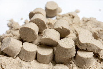 many small towers of kinetic sand. play with a child.