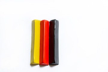 Three multi-colored plasticine bars on a white background. material for children's creativity. isolate.