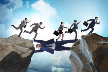 Businessman acting as a bridge in support concept