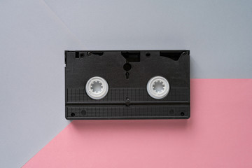 video cassette on pink grey pastel background. Retro style, top view