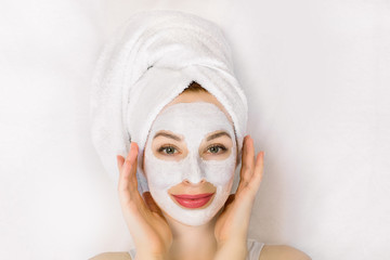 Beauty spa treatments, skin care. Close-up portrait of beautiful girl with a towel on her head and...