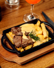 lamb steak and french fries and melted cheese