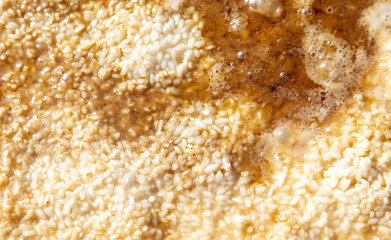 Pilaf with rice is cooked on a cast-iron cauldron.