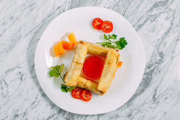 pancakes with meat and spicy sauce on a marble table