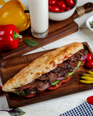 long beef doner with tomato red onion and cucumber