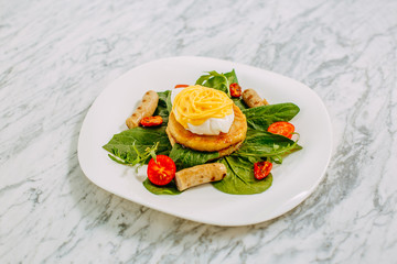 fritters with boiled egg and chicken sausages on a marble table