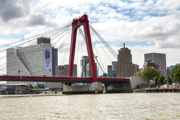 Red metal bridge, with suspension cables in Rotterdam, Holland, Netherlands.