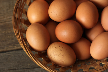 Eggs in a basket on a wooden background