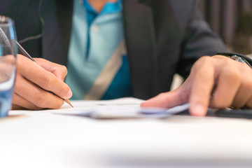 Businessman manager signing Document report and business note in meeting room concept: Start up writing for reading and learning in paperwork or documentation files at corporate office background.