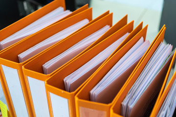 Document binder file folders stack on office desk in organization with report paper, paperwork record label, A lot of work information for businessman or lawyer organized archive database bookkeeping