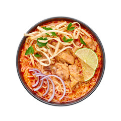 Khao Soi Gai or Thai Coconut Curry Noodle Soup in black bowl isolated on white background. Khao Soy is Thailand cuisine dish with noodles, chicken meat, red chillies paste and spices. Top view