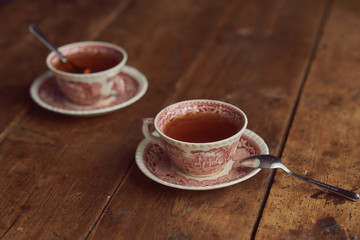two cups of tea on a wooden table