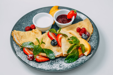 pancakes with strawberries, raspberries and jam, breakfast, healthy food isolated on white background