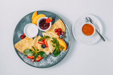 pancakes with strawberries, raspberries and jam, breakfast, healthy food isolated on white background