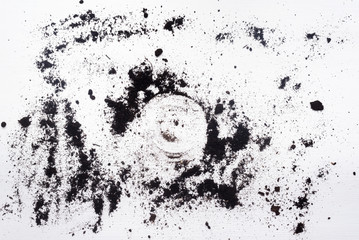 Black garden soil on white wooden table background.